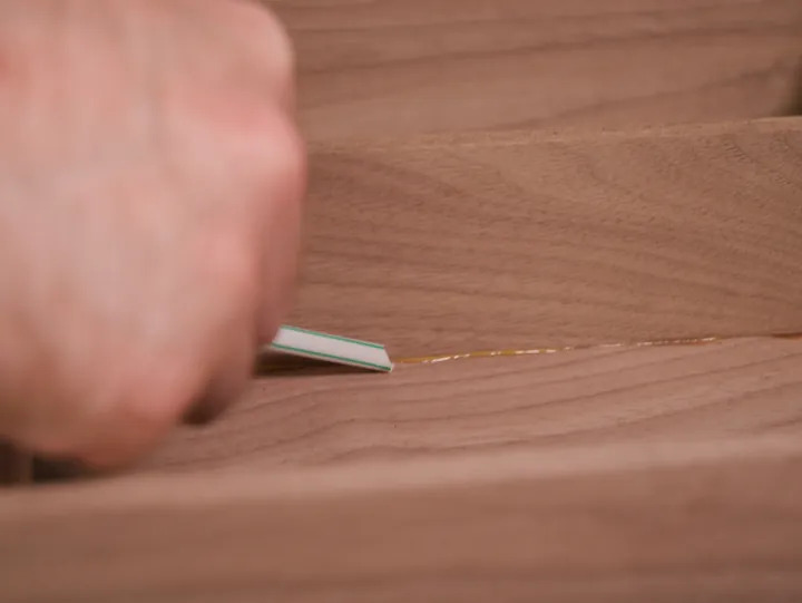 Using an angled drinking straw to remove glue squeeze-out from an inside corner