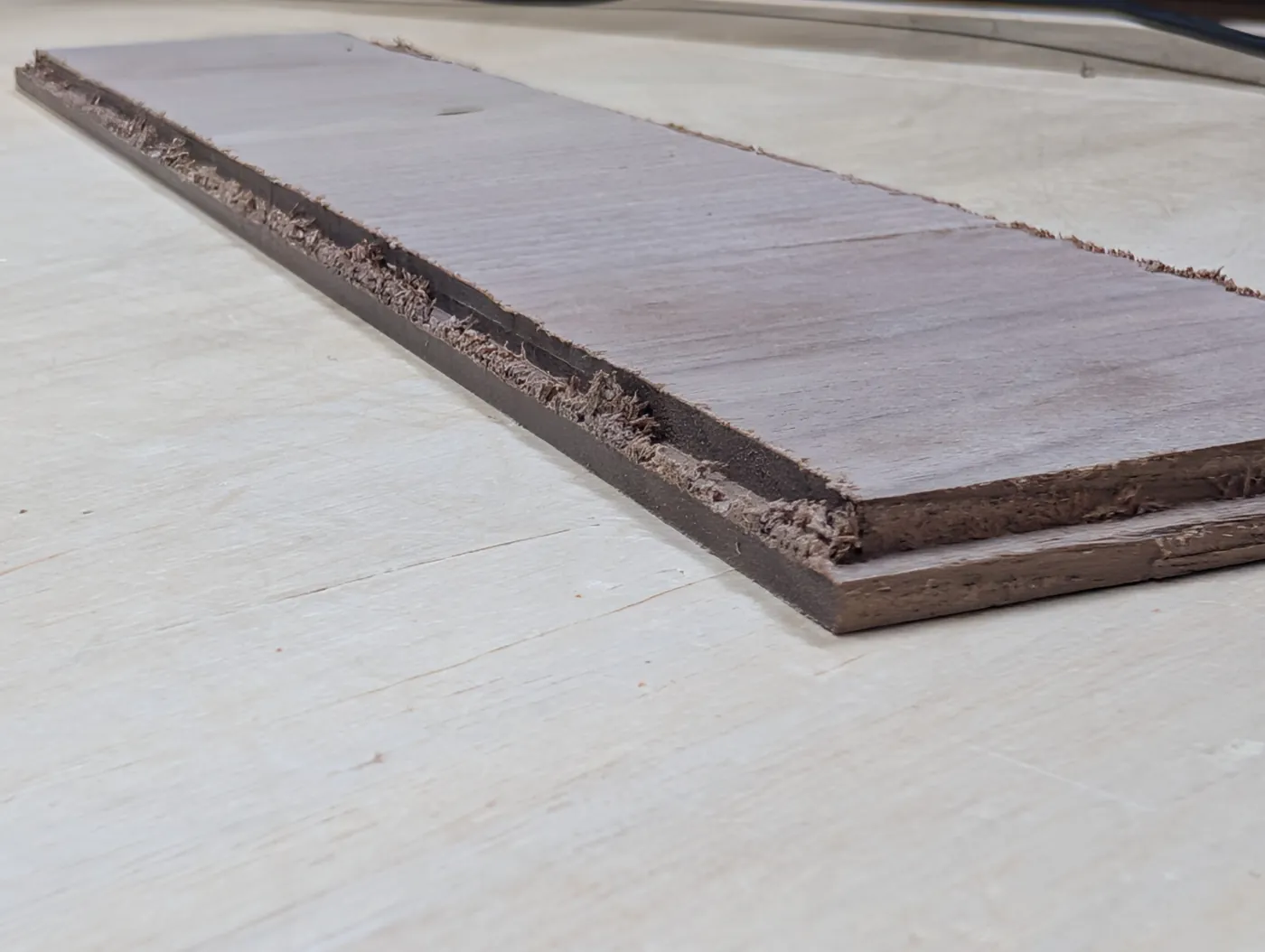 Fuzzy edges on a freshly CNC-cut walnut panel