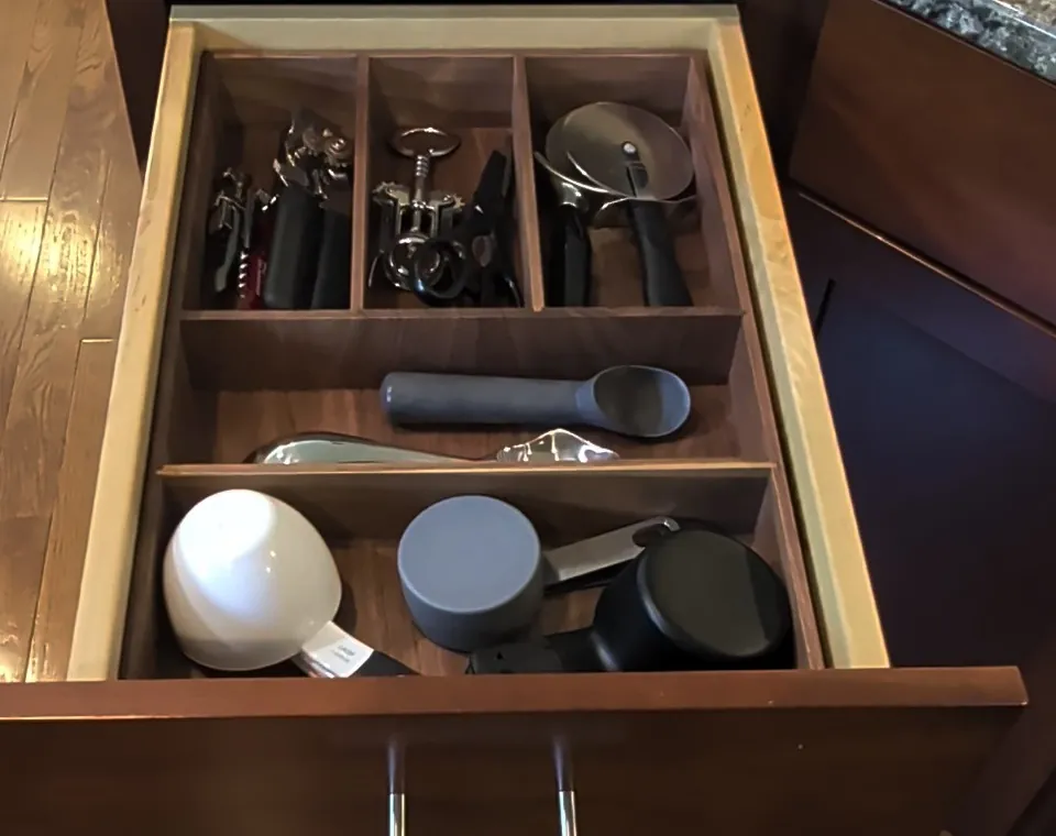 The same kitchen drawer fitted with a custom walnut organizer